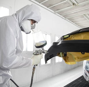 Collision Center Technician Painting a Vehicle | Central City Toyota in Philadelphia PA