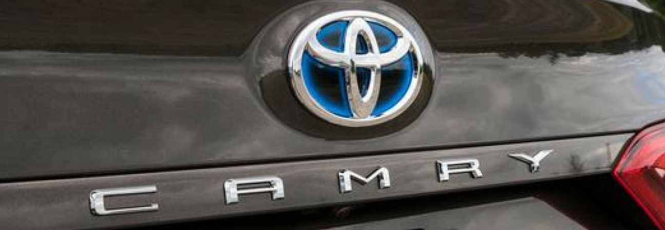 A close-up of the Toyota Camry's logo featured in a blog post about used Toyota Camry models